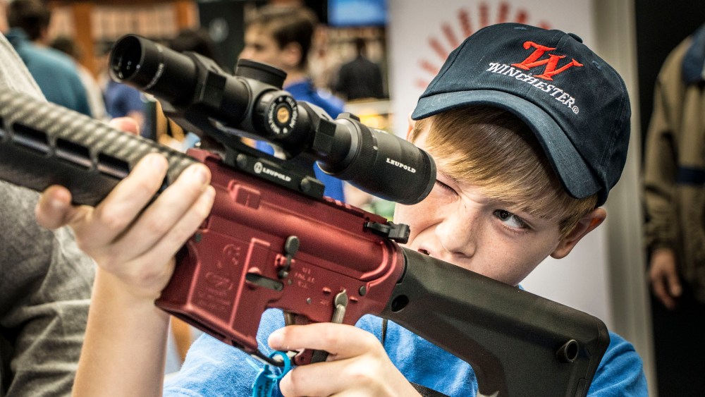 A twelve year old boy visits the Bushmaster booth during Family Day at the NRA convention at Lucas Oil Stadium in Indianapolis, April, 2014.
