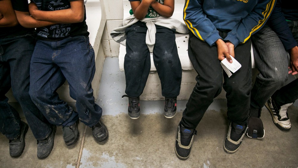 A Honduran child, unsure of his age, sits with other youths waiting to be processed at a U.S. Border Patrol station in Brownsville, Texas, March 25, 2014.