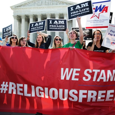 Activists gather outside the Supreme Court building Monday morning in Washington, June 30, 2014.