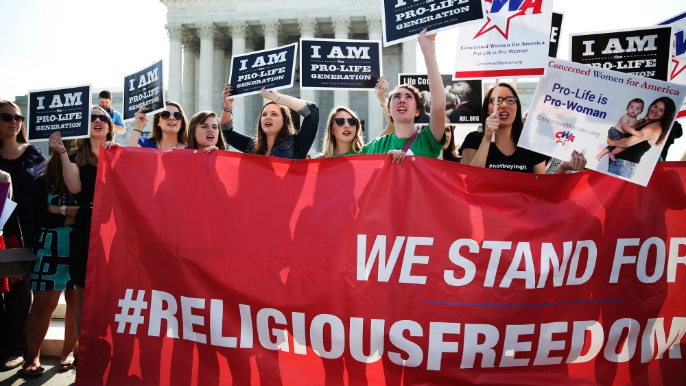 Activists gather outside the Supreme Court building Monday morning in Washington, June 30, 2014.