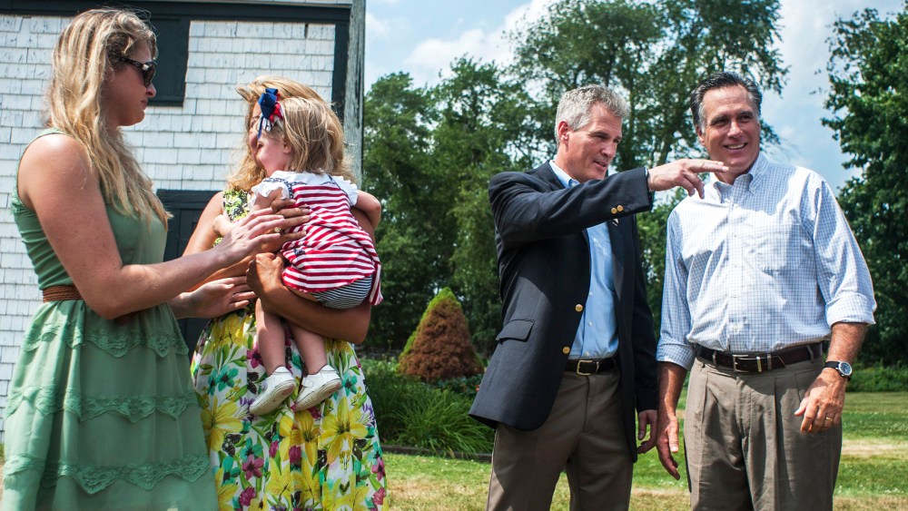 Mitt Romney speaks with Scott Brown in Stratham, N.H., July 2, 2014.