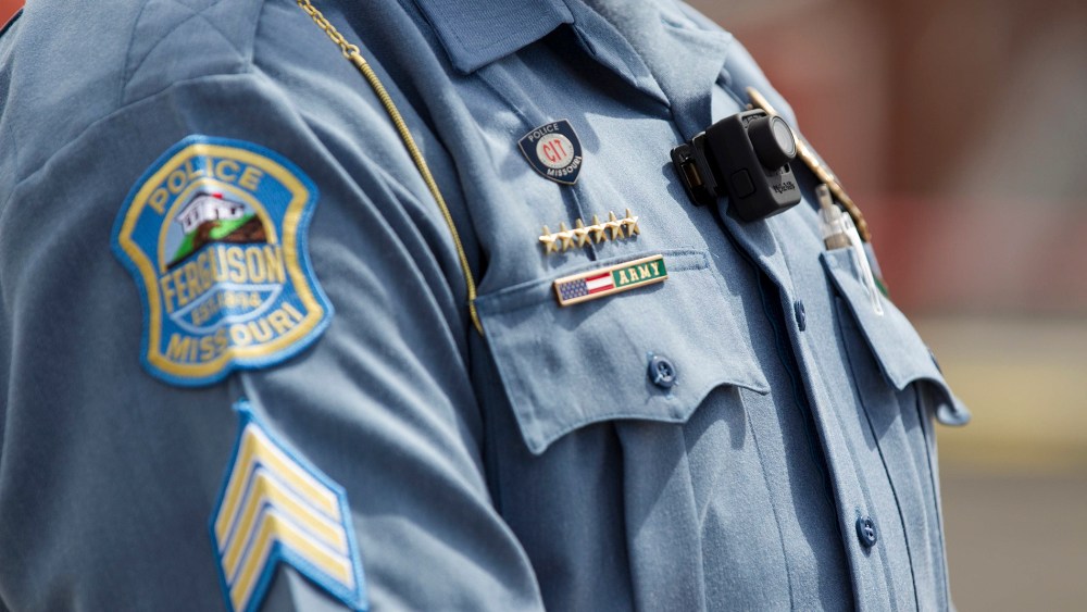 A Ferguson police officer wears a body camera during a news conference in Ferguson, Mo., Sept. 1, 2014.