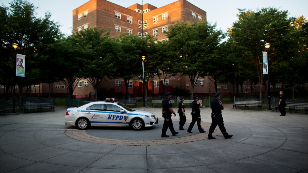 Officers walk past a parked patrol car in the Brooklyn borough of New York, N.Y. on June 24, 2014. (Photo by Victor J. Blue/The New York Times/Redux)
