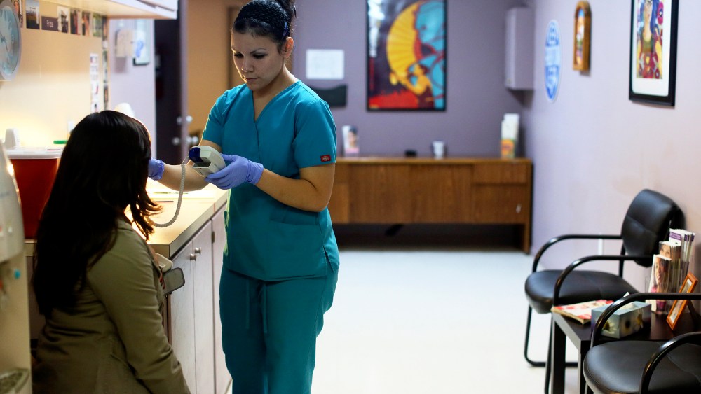 Nyla Munoz, a medical assistant, helps a patient through a pre-op appointment during the final day of seeing patients at Whole Women's Health Clinic, an abortion clinic, in McAllen, Texas.