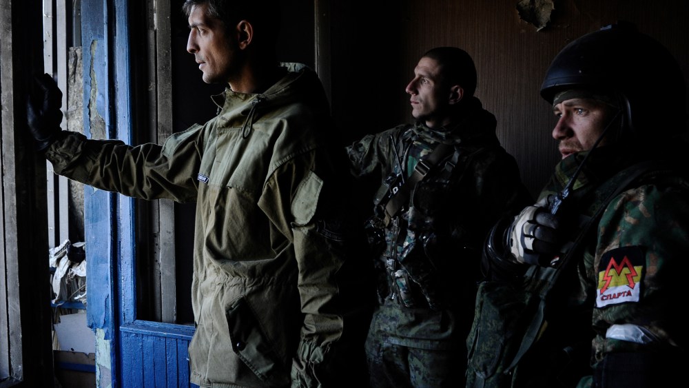 From a nearby building, a pro-Russian commander directs artillery fire upon the Ukrainian army positions at the airport in Donetsk, Ukraine, Oct. 4, 2014