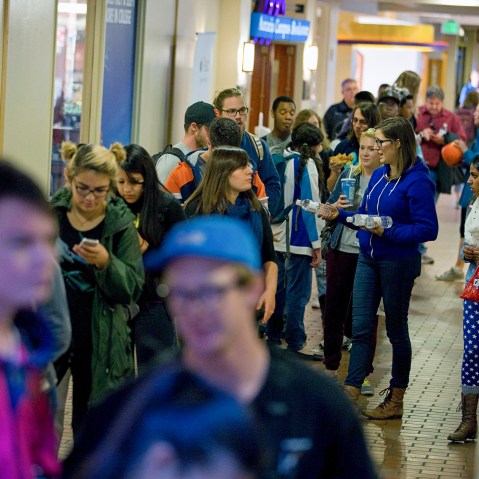 People wait in line to vote at busy polling facility on the Auraria Campus in Denver, Colo.