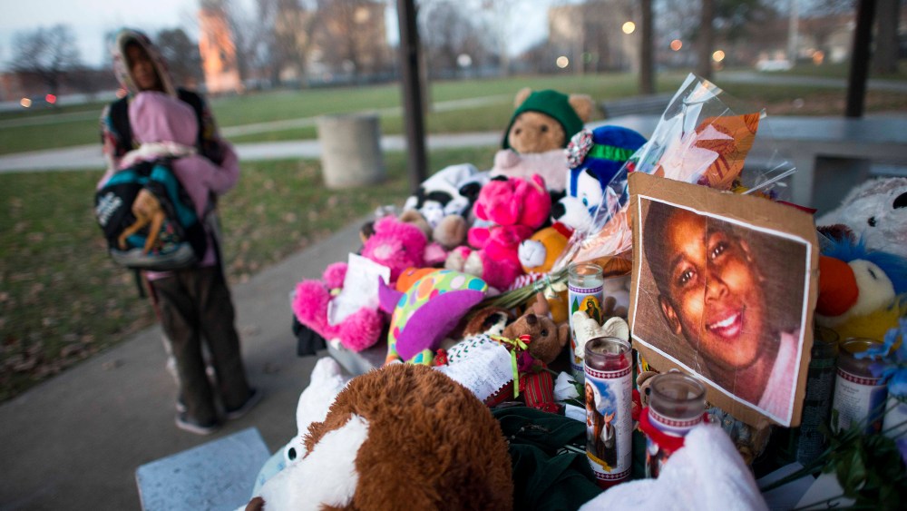 Kiara Jacobs, 8, hugs her brother Quentin Stamen, 13, at a memorial where Tamir Rice was fatally shot by Cleveland police officers who mistook the 12 year old's toy gun for a real gun.