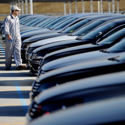 An employee looks over cars at the Volkswagen automobile assembly plant in Chattanooga, Tenn., on Feb. 21, 2012. (Photo by Erik S. Lesser/EPA)