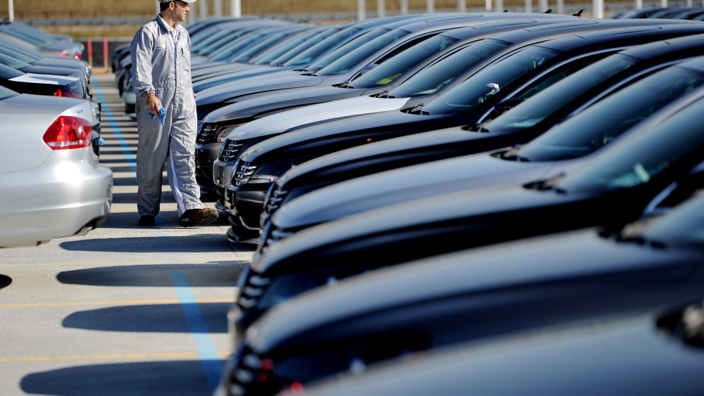 An employee looks over cars at the Volkswagen automobile assembly plant in Chattanooga, Tenn., on Feb. 21, 2012. (Photo by Erik S. Lesser/EPA)