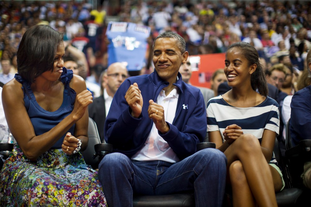 US President Barack Obama does a little dance while First Lady Michelle Obama and Malia Obama look on in Washington DC on July 16, 2012. (Photo by Jim Lo Scalzo/EPA)