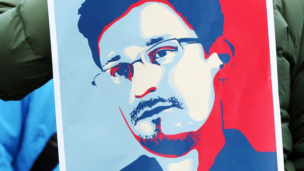 A demonstrator holds a poster of Edward Snowden in Hamburg, Germany, Dec. 28, 2013.
