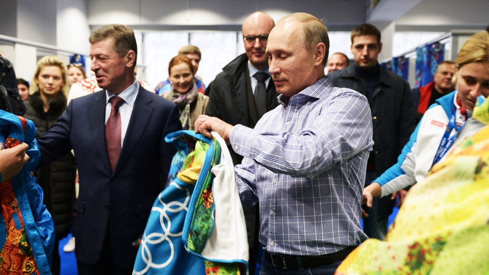 Russian President Vladimir Putin tries on a Sochi jacket, Jan. 4, 2014.