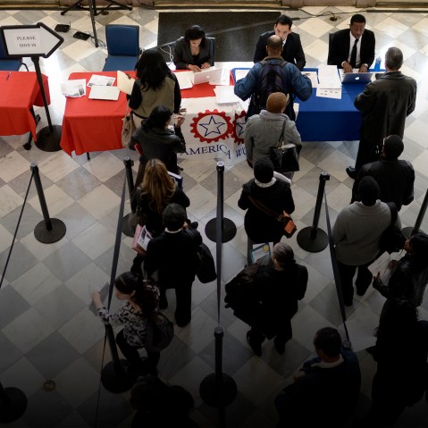 Job seekers wait to speak with employers at a job fair in Brooklyn, N.Y., on April 11, 2014. (Photo by Andrew Gombert/EPA)