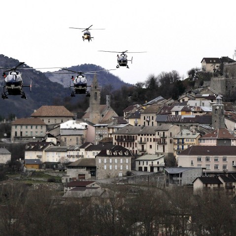Helicopters of the French gendarmerie and emergency services fly over Seyne-les-Alpes as they resume works to recover the bodies and the remains of the Airbus A320 that crashed the previous day in the French Alps on March 25, 2015. (Alberto Estevez/EPA)