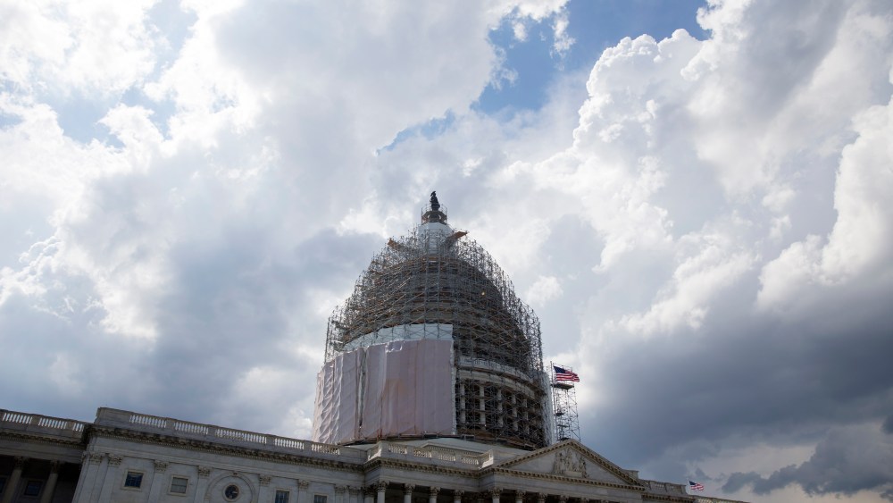 Storm clouds pass near the US Capitol Building, in Washington DC on June 1, 2015. (Photo by Michael Reynolds/EPA)