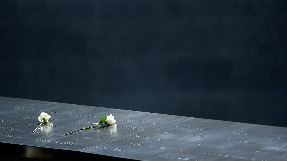 Roses sit on the edge of the south pool of the 9/11 Memorial in New York, N.Y., on Sept. 25, 2015. (Photo by CJ Gunther/EPA)