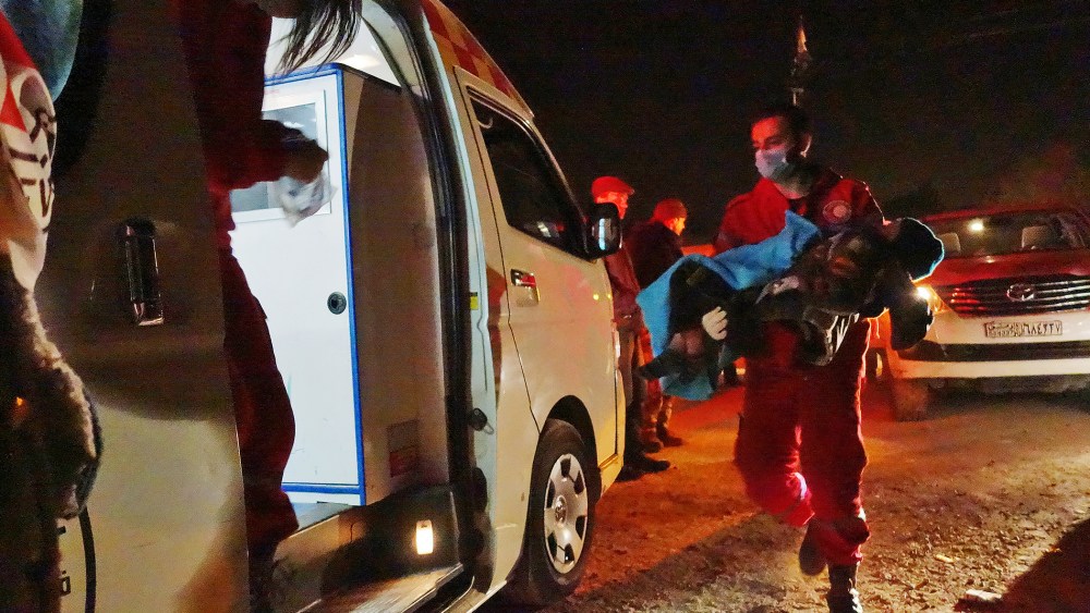 A handout photo dated late Feb. 3, 2016 shows a severely ill child being evacuated by Syrian Arab Red Crescent first aiders from the besieged city of Moadamiyeh, Syria. (Photo by Pawel Krzysiek/Handout/EPA)