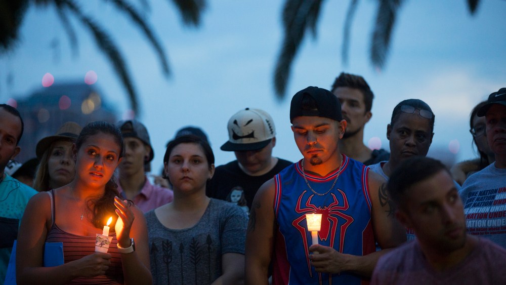 Community members gather for a vigil to honor the victims of a mass shooting at a nightclub, at Eola Lake Park in Orlando, Fla., on June 12, 2016. (Photo by Ryan Stone/EPA)