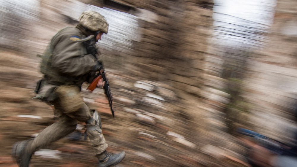 A Ukrainian serviceman runs as he patrols the area in Vodyanoe village, near Mariupol, Ukraine on  Nov. 10, 2016. (Photo by Sergey Vaganov/EPA)