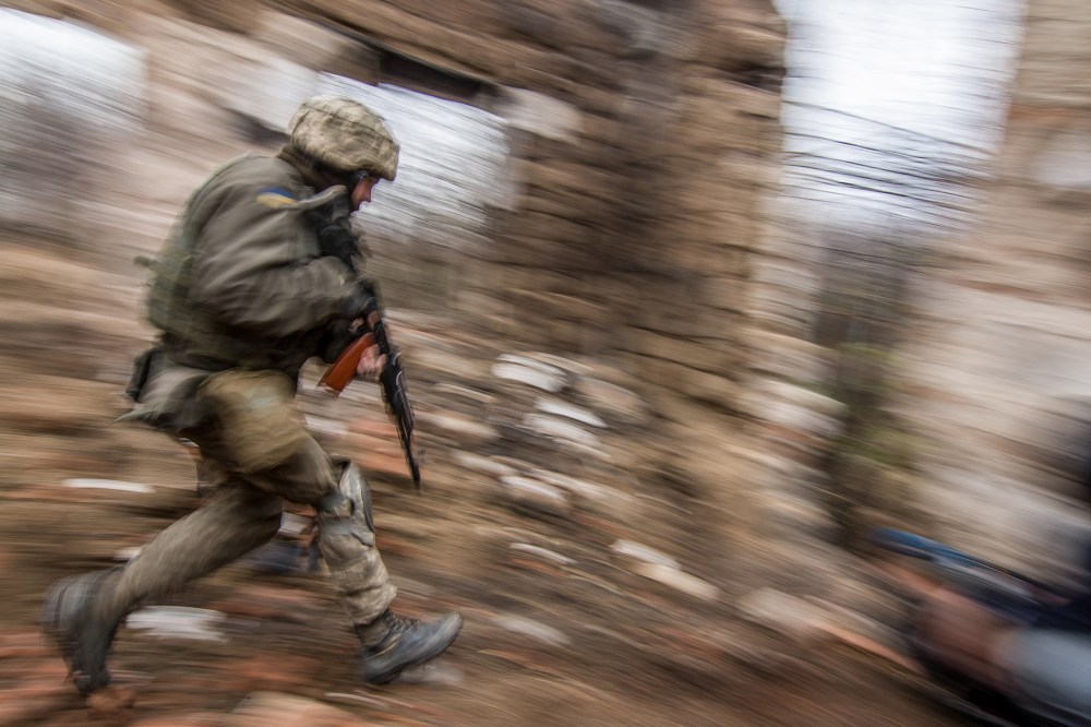 A Ukrainian serviceman runs as he patrols the area in Vodyanoe village, near Mariupol, Ukraine on  Nov. 10, 2016. (Photo by Sergey Vaganov/EPA)