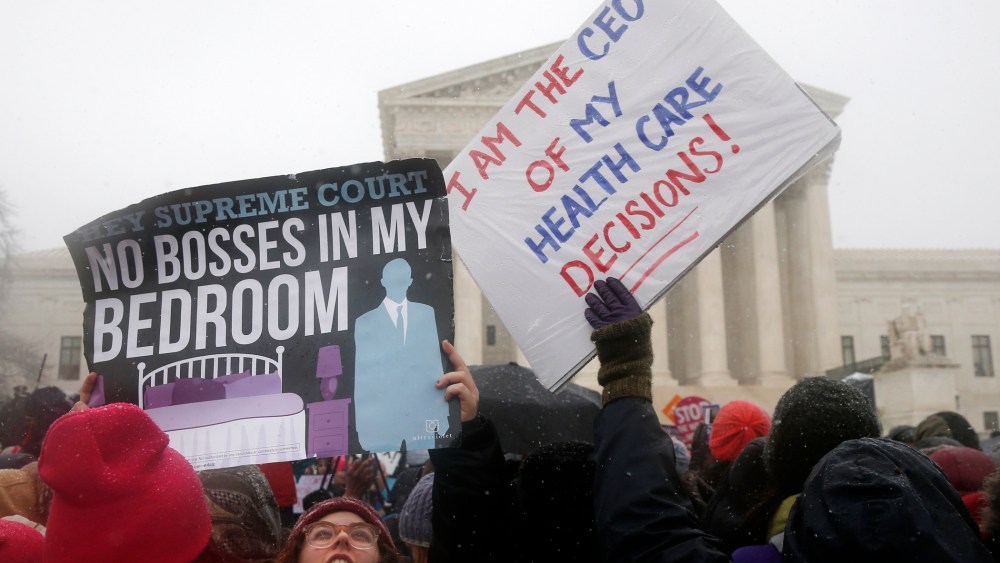 Demonstrators gather in front of the Supreme Court in Washington, Tuesday, March 25, 2014.