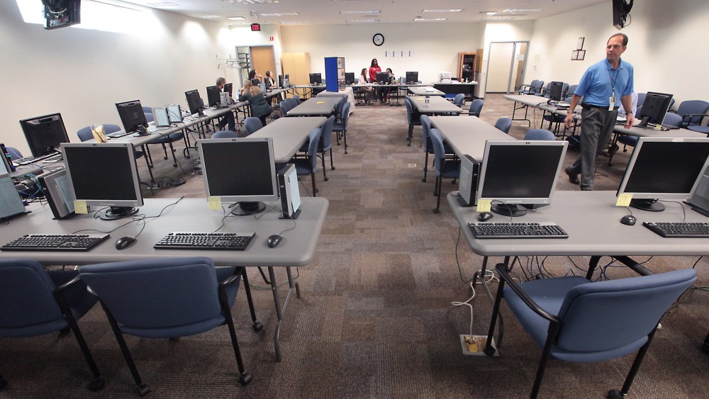 Computer stations equipped to help consumers enroll in a new health insurance exchange await potential enrollees at the Dane County Job Center in Madison, Wis. Tuesday, Oct. 1, 2013.
