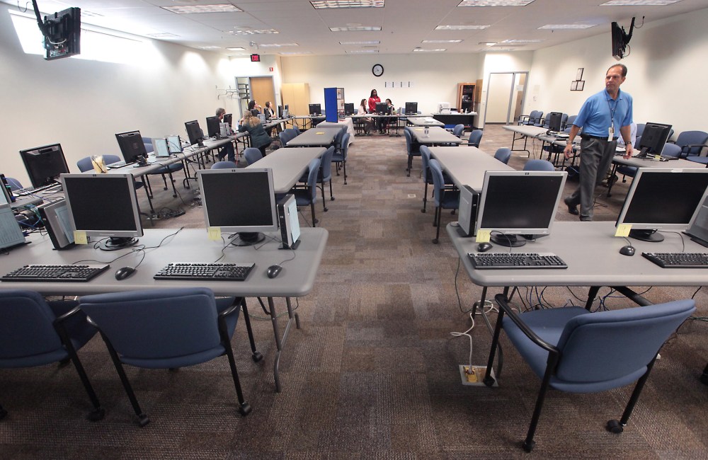 Computer stations equipped to help consumers enroll in a new health insurance exchange await potential enrollees at the Dane County Job Center in Madison, Wis. Tuesday, Oct. 1, 2013.