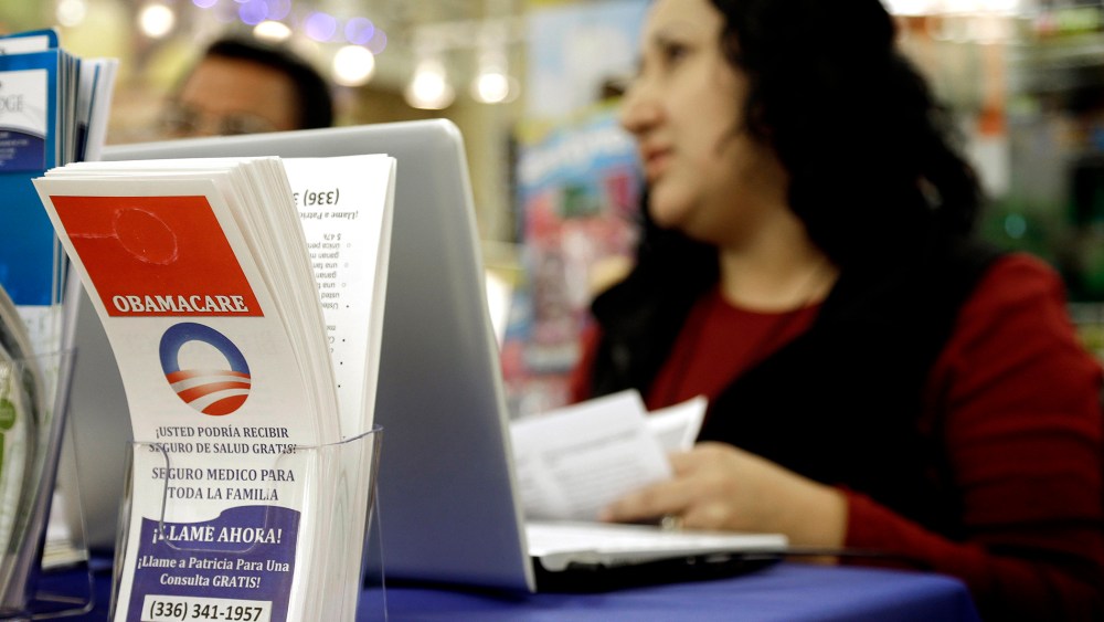 Blue Bridge Benefits LLC agent Patricia Sarabia helps customers interested in Obama Care at a kiosk at Compare Foods in Winston-Salem, N.C. on Nov. 22, 2014.