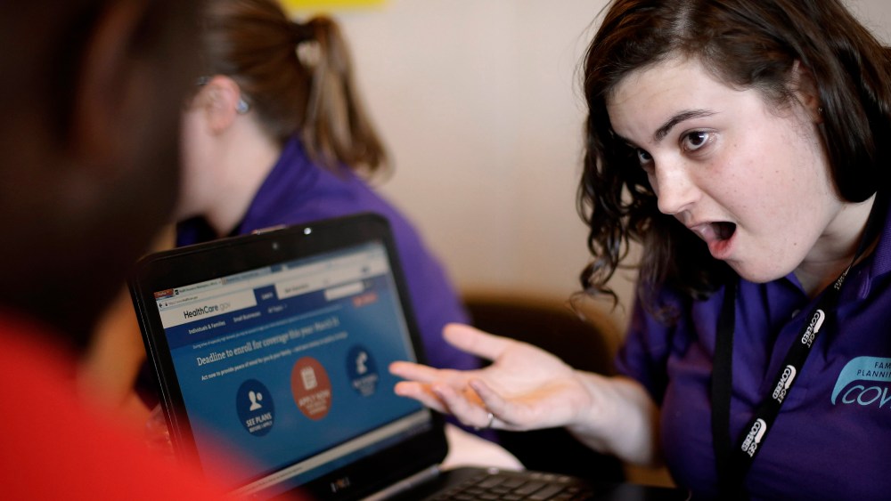 Elizabeth Rich helps a man sign up for the Affordable Care Act at Swope Health Services in Kansas City, Mo., March 31, 2014.