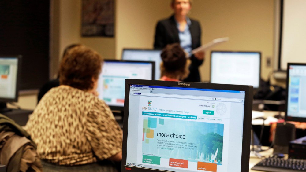 In this photo made Wednesday, November 13, 2013, Maureen O'Connell addresses people in attendance at the "MNsure Crash Course" at the St. Paul Library to help them understand how federal health care reform affects their lives.