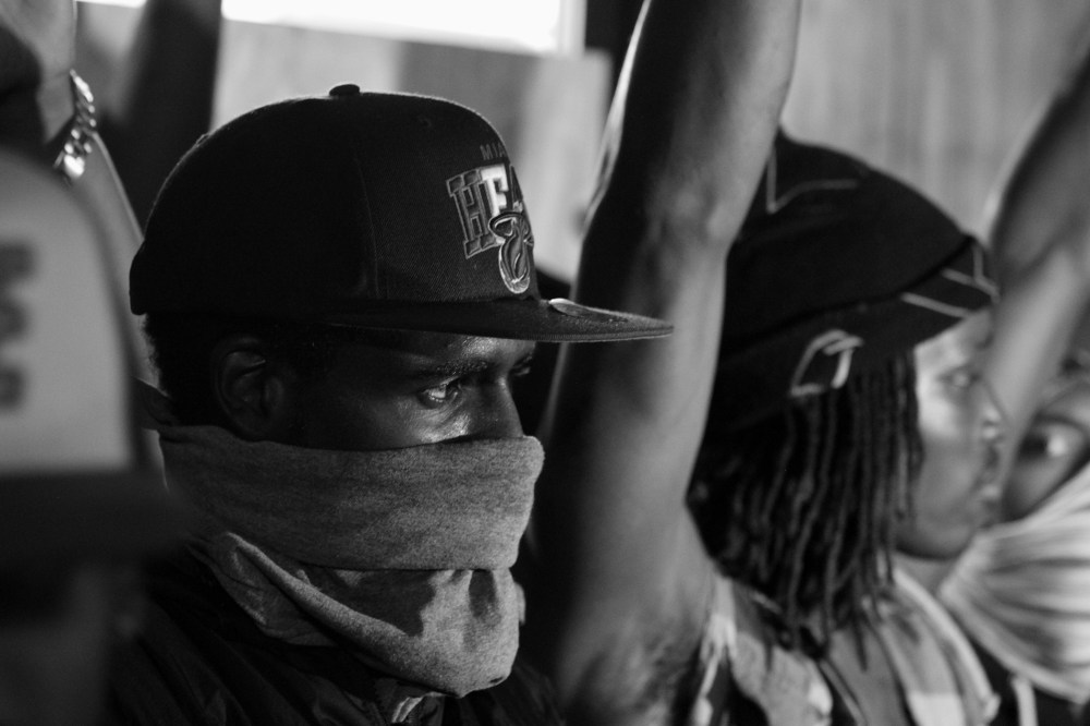 One of several young men is seen guarding a liquor store from being looted early on Saturday morning in Ferguson, Mo., Aug. 16, 2014.