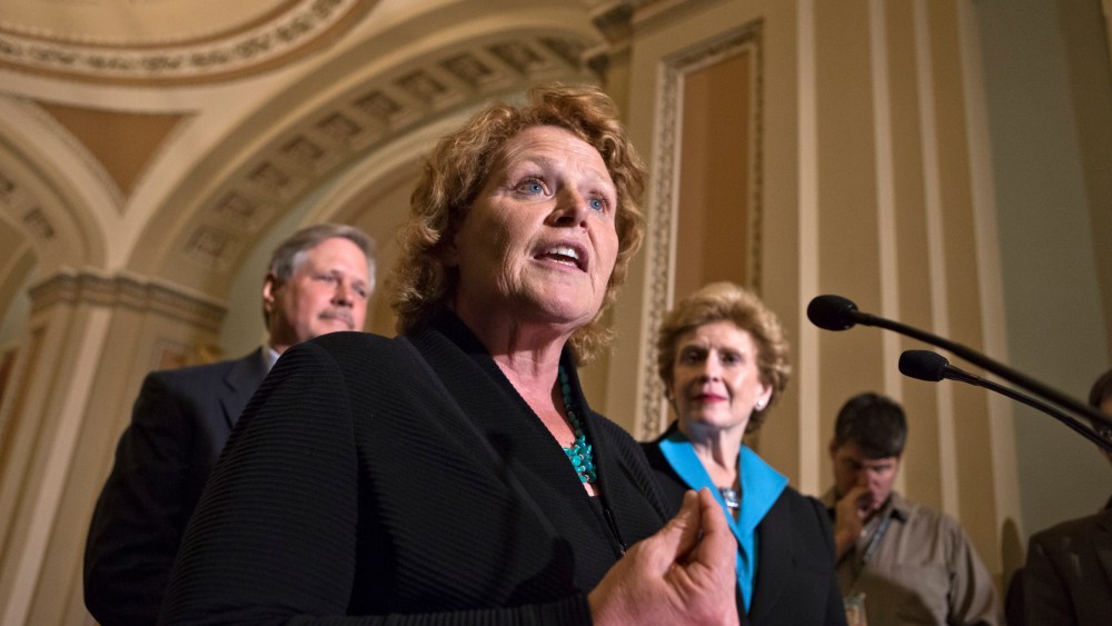 Sen. Heidi Heitkamp, D-N.D., center, joins Sen. Debbie Stabenow, D-Mich., chairwoman of the Senate Agriculture Committee, right, and Sen. John Hoeven, R-ND, left, to speak to reporters as the Senate votes on a farm bill that sets policy for farm...