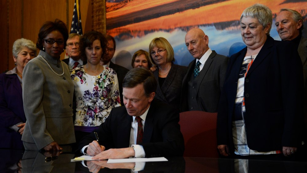 Colorado Governor John Hickenlooper signs three gun control bills into law in his office at the state capitol in Denver, Colorado, March, 20, 2013. The three gun control bills include one banning ammunition magazines with more than 15 rounds in a state...
