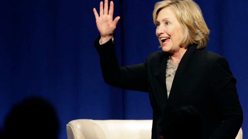 Former U.S. Secretary of State Hillary Rodham Clinton waves as she leaves the Economic Club of Chicago in Chicago on Oct. 8, 2014. (Nam Y. Huh/AP)