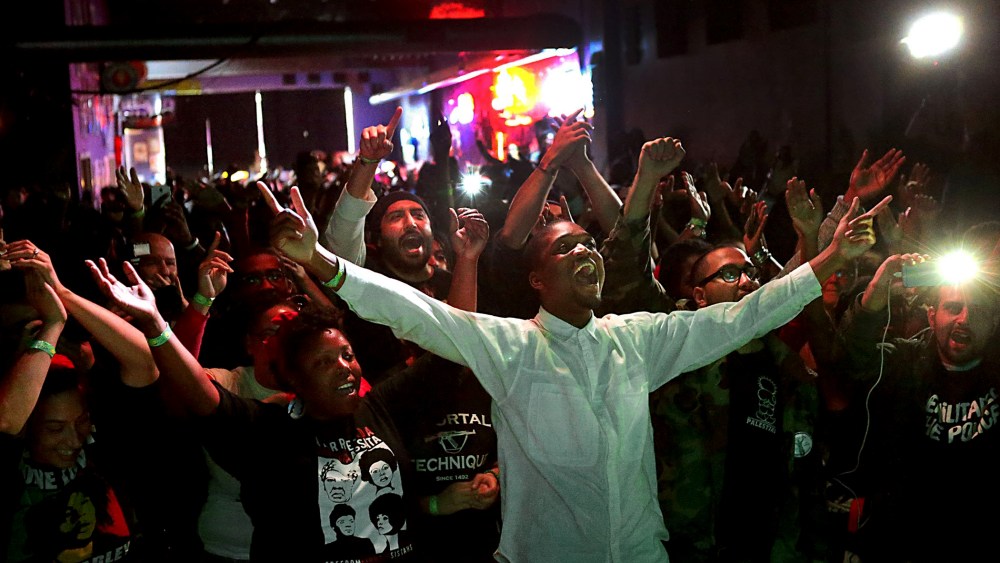 Hip hop fans watch Talib Kweli during the "Hip Hop and Resistance" concert at Fubar on Locust Street in St. Louis, Mo., on Oct. 12, 2014. (Robert Cohen/St. Louis Post-Dispatch/AP)
