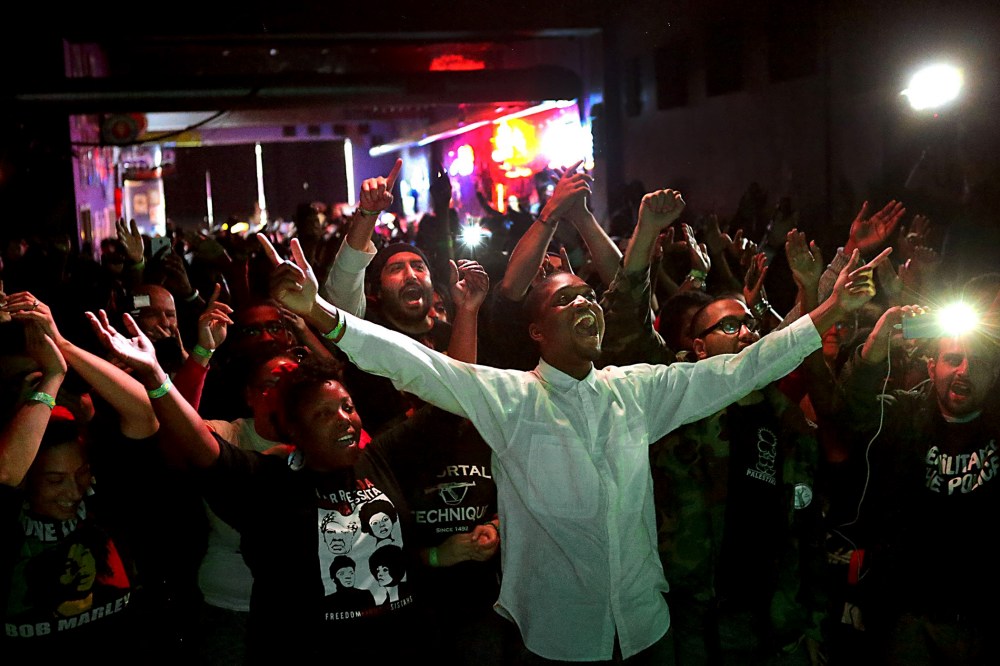 Hip hop fans watch Talib Kweli during the "Hip Hop and Resistance" concert at Fubar on Locust Street in St. Louis, Mo., on Oct. 12, 2014. (Robert Cohen/St. Louis Post-Dispatch/AP)