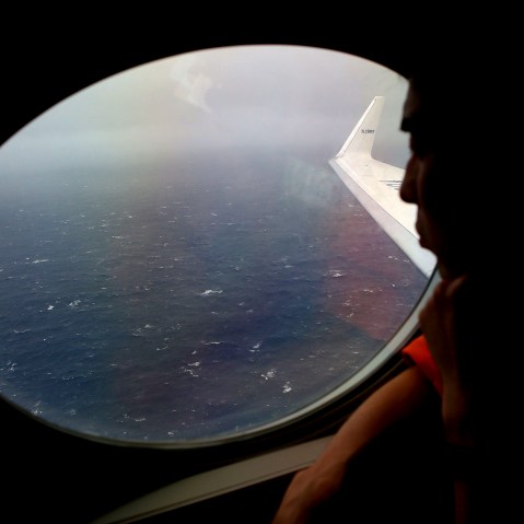 Koji Kubota of the Japan Coast Guard keeps watch for debris on board the Japan Coast Guard Gulfstream V aircraft whilst in the search zone for debris from Malaysia Airlines flight MH370 on April 1, 2014.