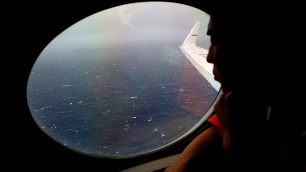 Koji Kubota of the Japan Coast Guard keeps watch for debris on board the Japan Coast Guard Gulfstream V aircraft whilst in the search zone for debris from Malaysia Airlines flight MH370 on April 1, 2014.