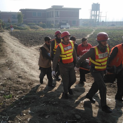 Pakistani rescuers shift an injured victim outside the Bacha Khan university following an attack by gunmen in Charsadda, about 50 kilometres from Peshawar, on Jan. 20, 2016. (Photo by A Majeed/AFP/Getty)