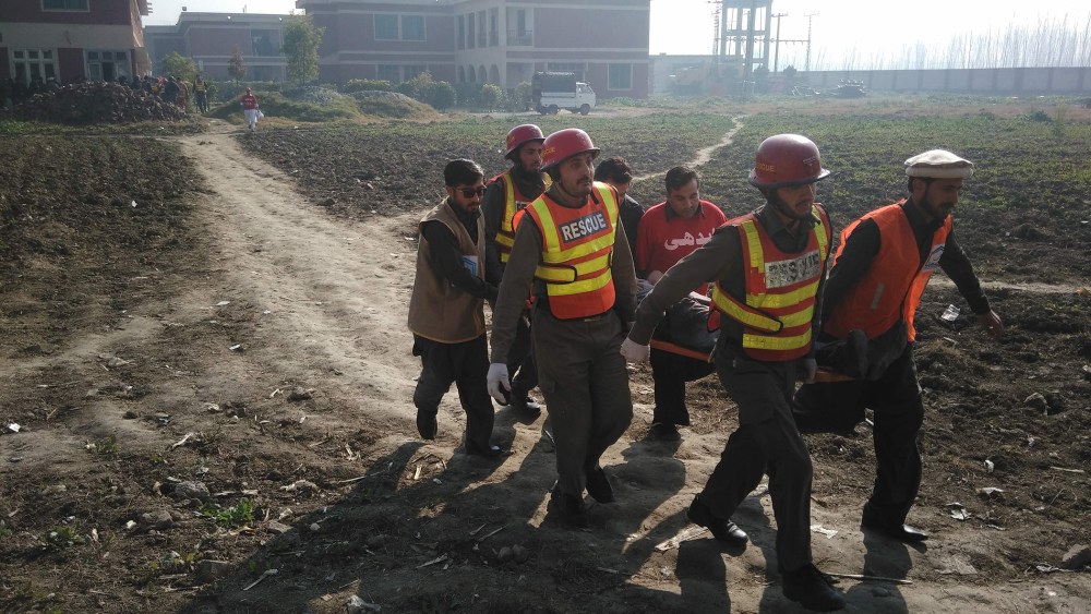Pakistani rescuers shift an injured victim outside the Bacha Khan university following an attack by gunmen in Charsadda, about 50 kilometres from Peshawar, on Jan. 20, 2016. (Photo by A Majeed/AFP/Getty)