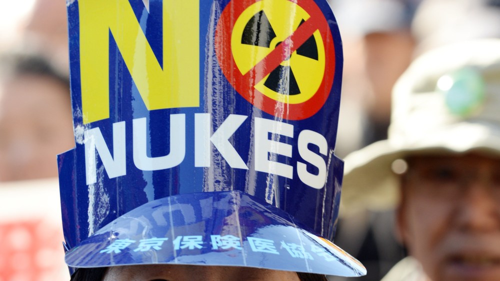A protester wears a "No Nukes" hat during an anti-nuclear demonstration march in Tokyo on March 15, 2014.