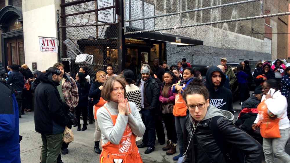 Home Depot employees and customers stand outside a store after shots were fired in a Chelsea, New York City location on Jan. 25, 2015. (Photo by David Hashim/MSNBC)