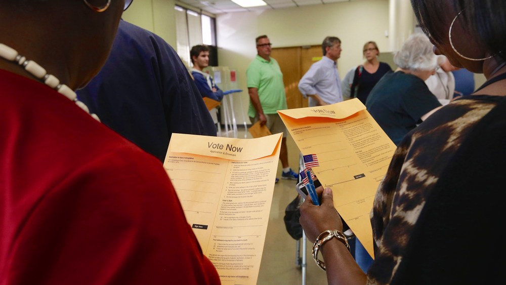 Early voters wait in line to get their ballots at the Douglas County Election Commission offices in Omaha, Neb., on Oct. 24, 2014.