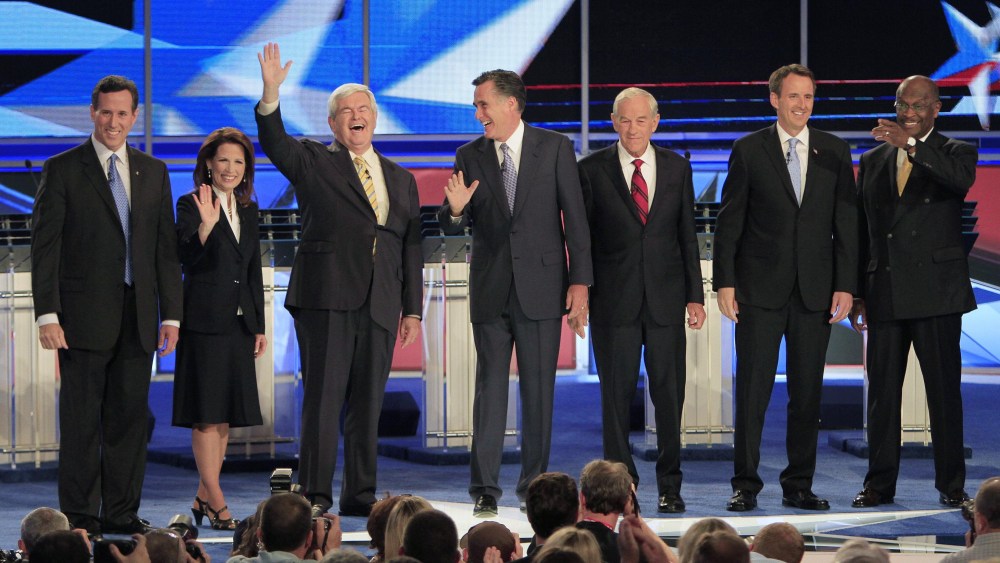From left, former Pennsylvania Sen. Rick Santorum, Rep. Michele Bachmann, R-Minn., former House Speaker Newt Gingrich, former Massachusetts Gov. Mitt Romney, Rep. Ron Paul, R-Texas, former Minnesota Gov. Tim Pawlenty and businessman Herman Cain stand...