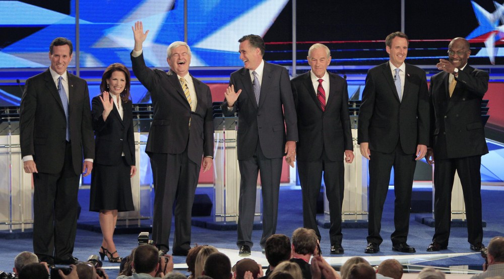 From left, former Pennsylvania Sen. Rick Santorum, Rep. Michele Bachmann, R-Minn., former House Speaker Newt Gingrich, former Massachusetts Gov. Mitt Romney, Rep. Ron Paul, R-Texas, former Minnesota Gov. Tim Pawlenty and businessman Herman Cain stand...