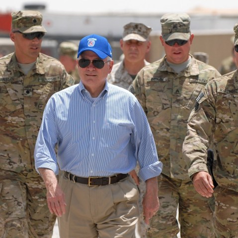 In this photo provided by ISAF Regional Command (South), U.S. Secretary of Defense Robert M. Gates walks with a group of service members at Forward Operating Base Walton, Sunday, June 5, 2011, in Kandahar, Afghanistan.