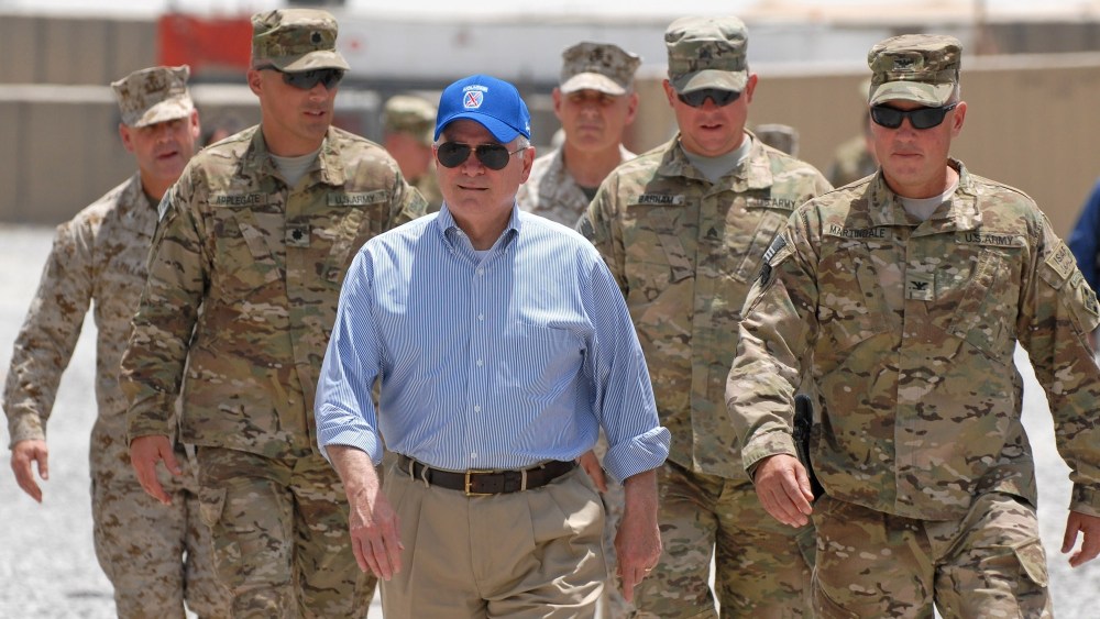 In this photo provided by ISAF Regional Command (South), U.S. Secretary of Defense Robert M. Gates walks with a group of service members at Forward Operating Base Walton, Sunday, June 5, 2011, in Kandahar, Afghanistan.