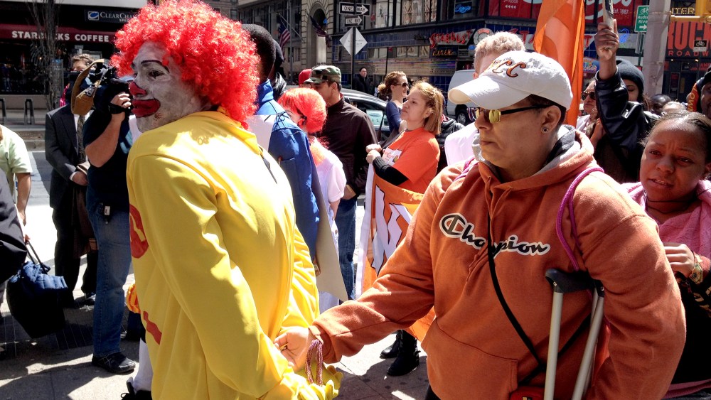 A protestor dressed as Ronald McDonald is given a mock "perp walk" during a protest against wages in the fast food industry, on April 3, 2014 in New York City.