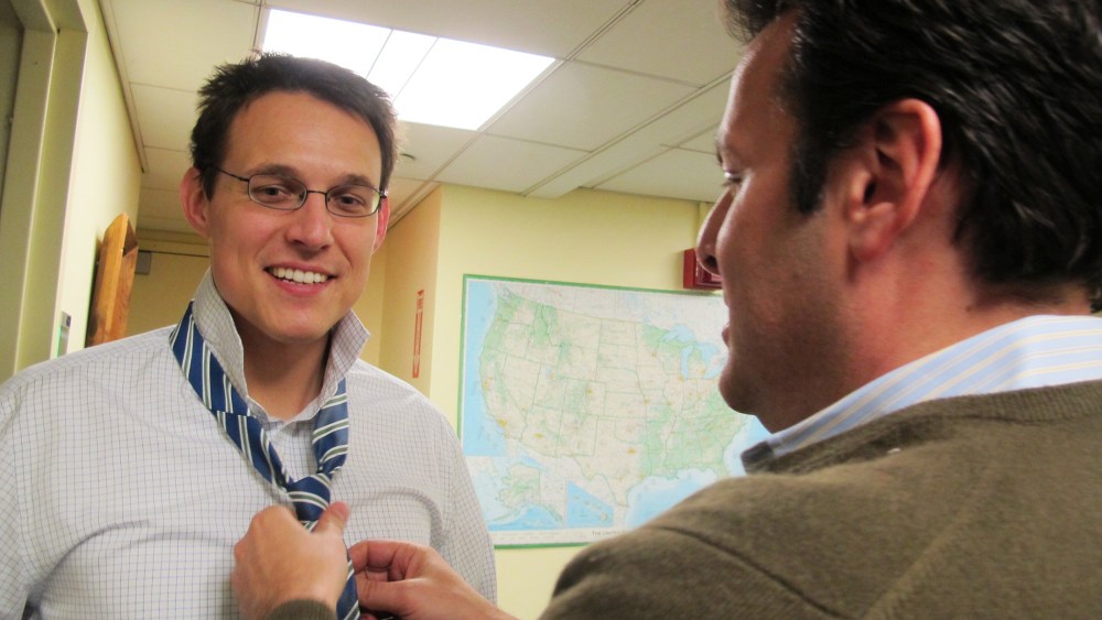 Bill Wolff, executive producer for The Rachel Maddow Show, helps Steve Kornacki tie his necktie before guest hosting, December 18, 2013.