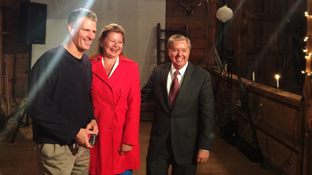 Sen. Scott Brown and his wife, journalist Gail Huff, pose with Sen. Lindsey Graham after the presidential candidate spoke at one of Brown's “No BS Backyard BBQs.” (Photo by Kailani Koenig)